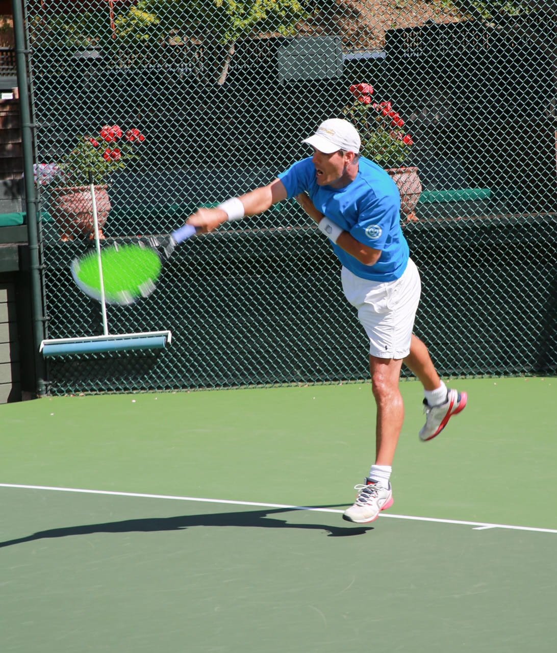Scott Howard following through after a tennis serve